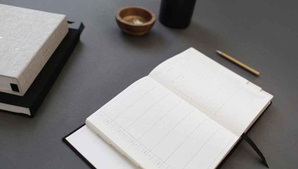A journal notebook opened on the desk | How to keep a business journal notebook