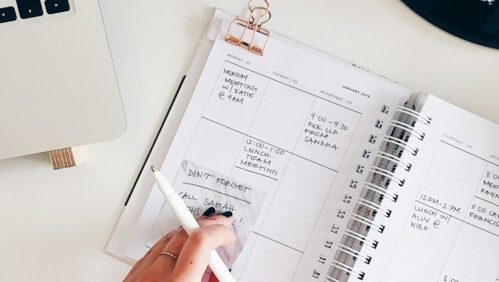 Woman creating a to-do list since it’s one of the best productivity tips for ADHD. 
