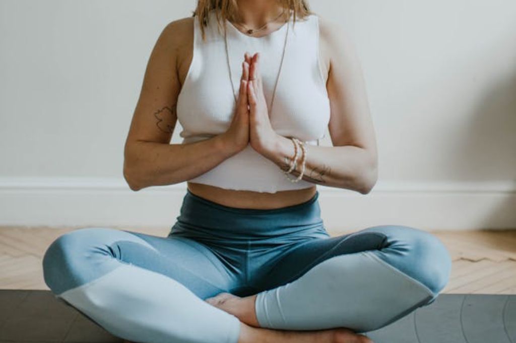 Woman reciting daily affirmations for women in meditation pose.