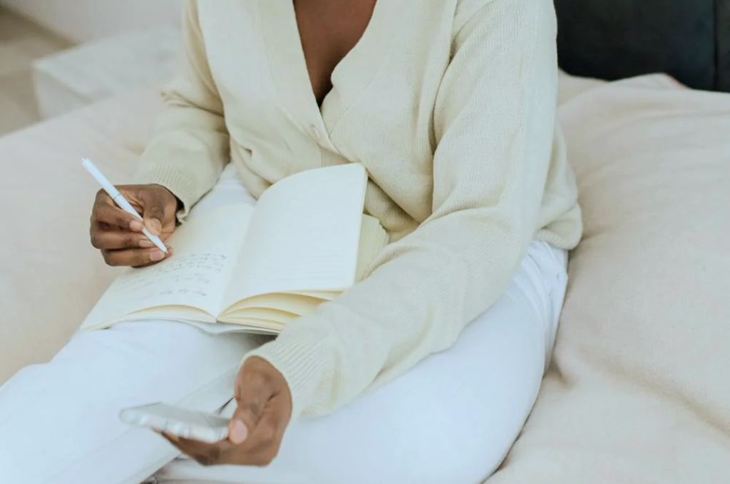 Woman writing an entry in her journal