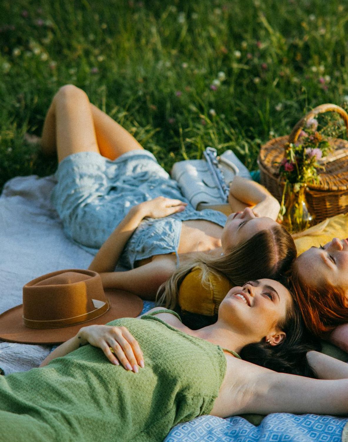 Ladies playing hot seat questions game during picnic