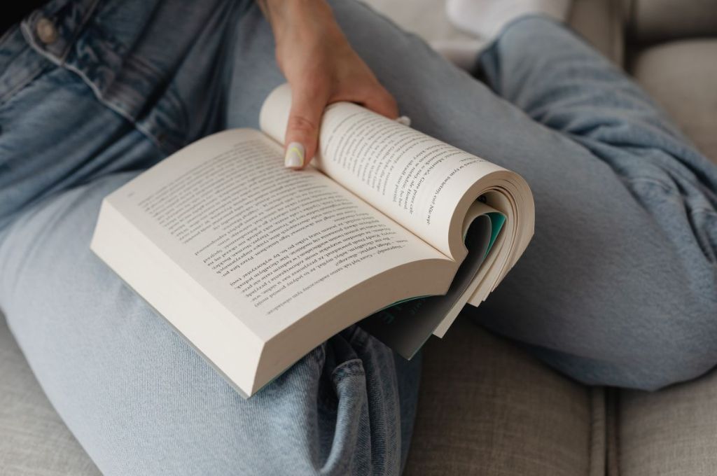 Woman reading a book from the best winter books collection.