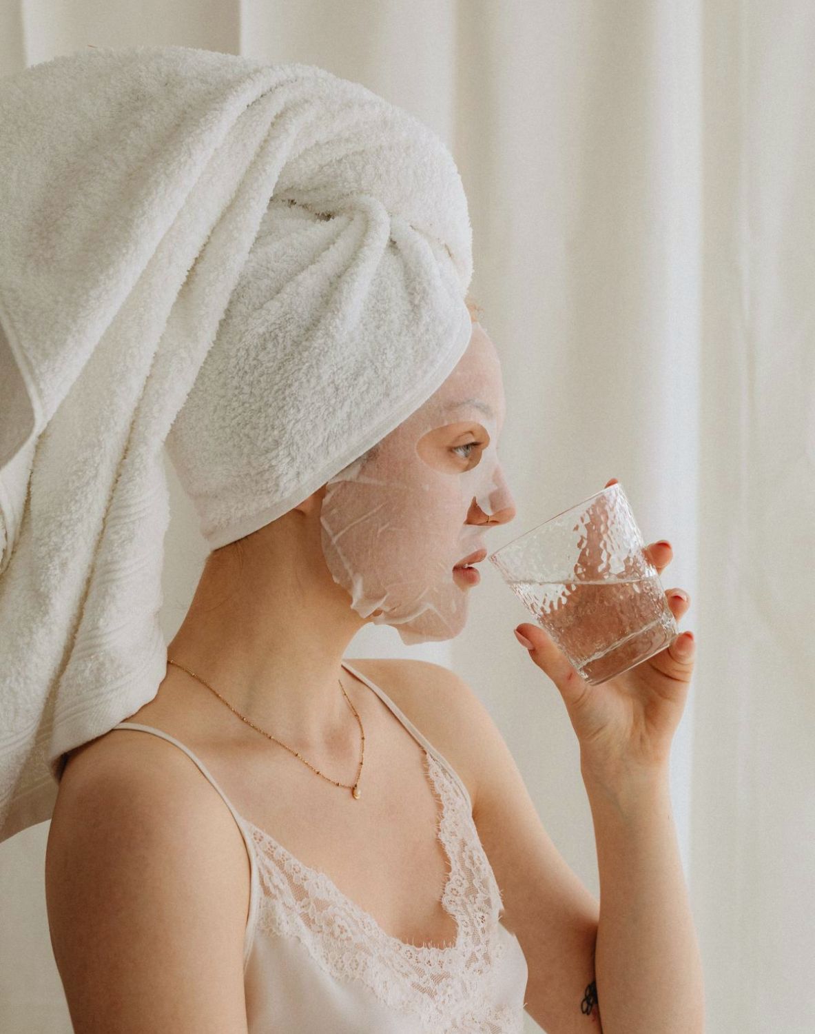 woman drinking water as a glow up tip